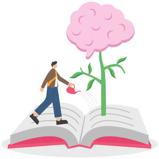 A person watering a plant grown on a book